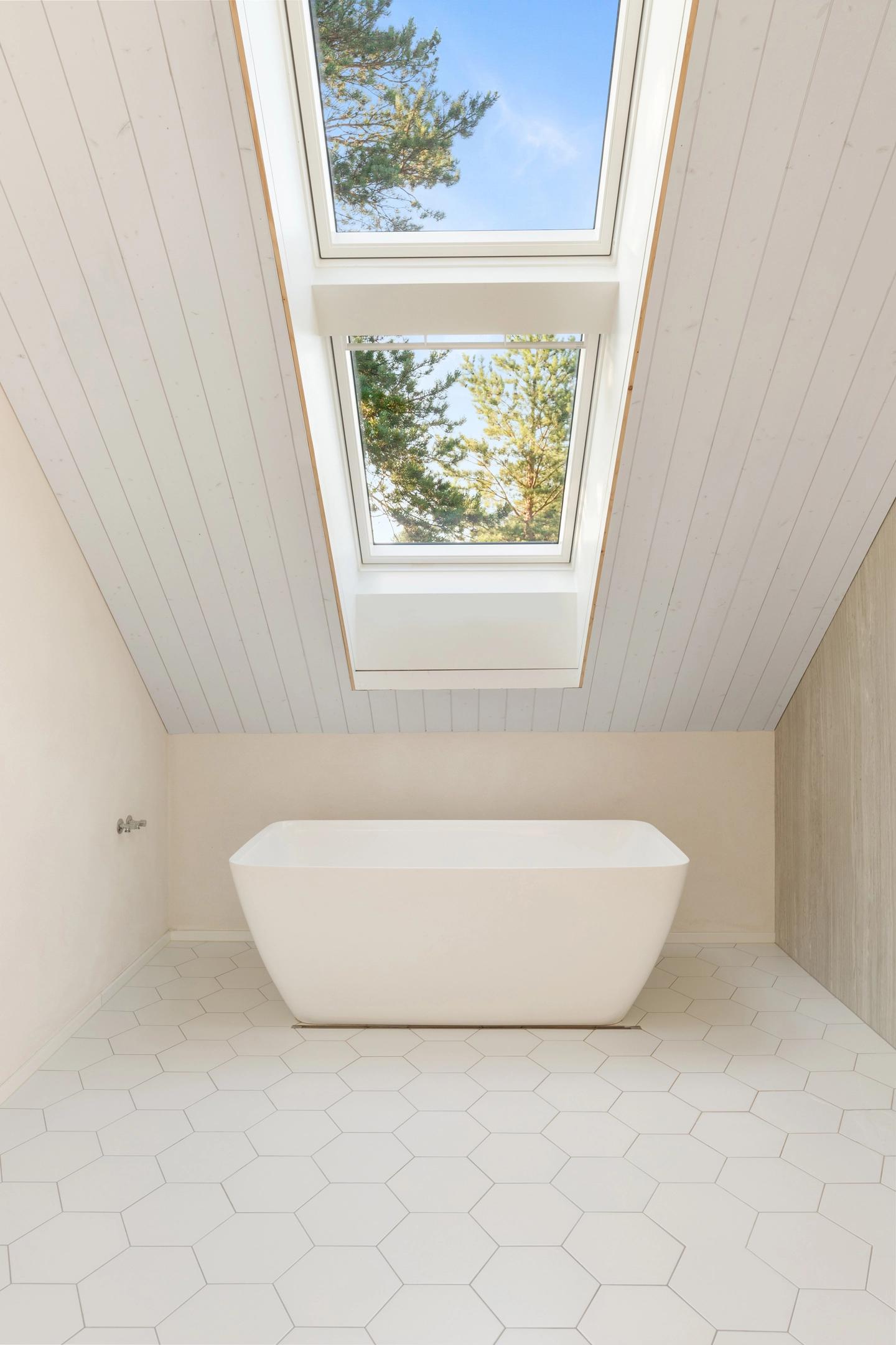 Minimalist white bathroom in private house in Suurupi