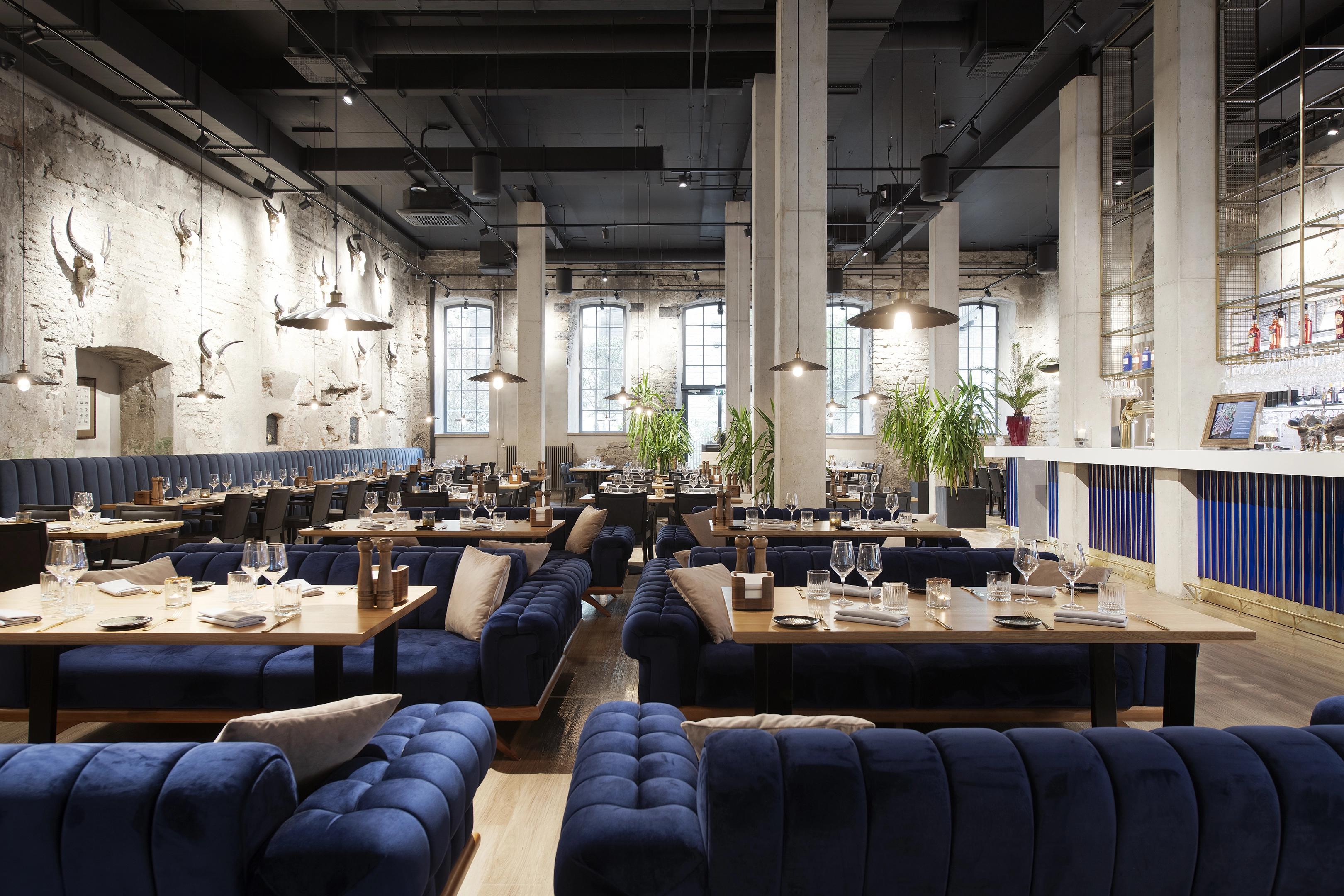 Comfy industrial interior of Argentina restaurant.